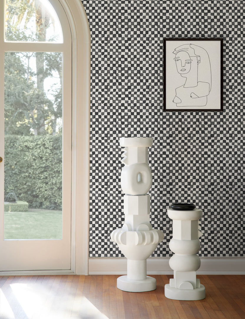 #size::tall #size::short | The Toivo short and tall pedestals stand next to each other in a room with checkerboard walls
