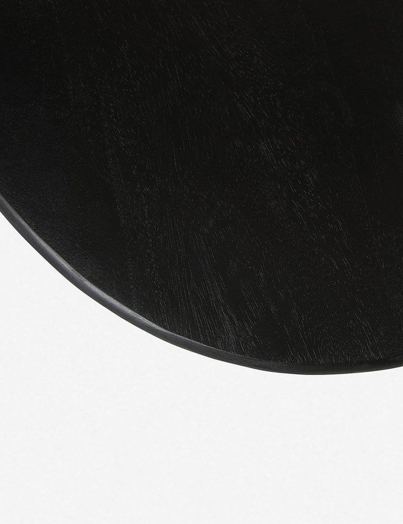 | Bird's-eye view of the circular top on the Corso black mango wood side table