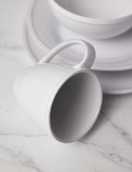 #color::white | Close-up of the mug in the Friso white dinnerware 5-piece place setting by Costa Nova