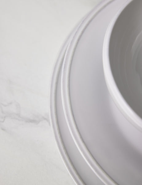 #color::white | Close-up of the grooved edge on the Friso white dinnerware 5-piece place setting by Costa Nova