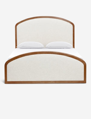 Crawford natural linen upholstered platform bed with an arched, wooden-framed headboard