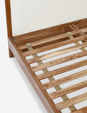 The wooden support beams on the inside of the Crawford natural linen platform bed