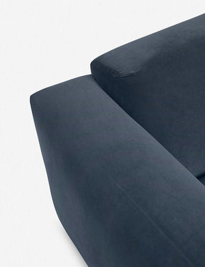 Where the arm and back-cushions of the Eleanor Blue Velvet sofa connect