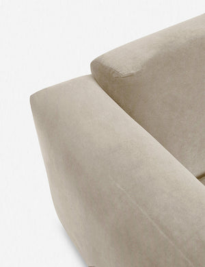 Where the arm and back-cushions of the Eleanor oatmeal beige Velvet sofa connect