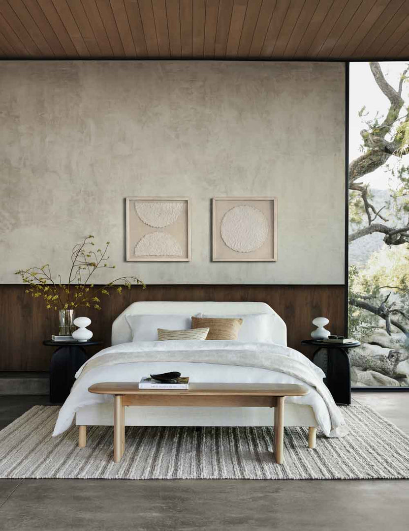 | Sonnet II & I Wall Art are hung above a white framed bed in a bedroom with two black nightstands and a striped rug
