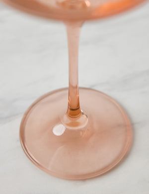 Close-up of the base and stem of the blush pink wine glass by Estelle Colored Glass