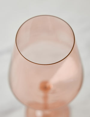 Angled view of a blush pink wine glass by Estelle Colored Glass
