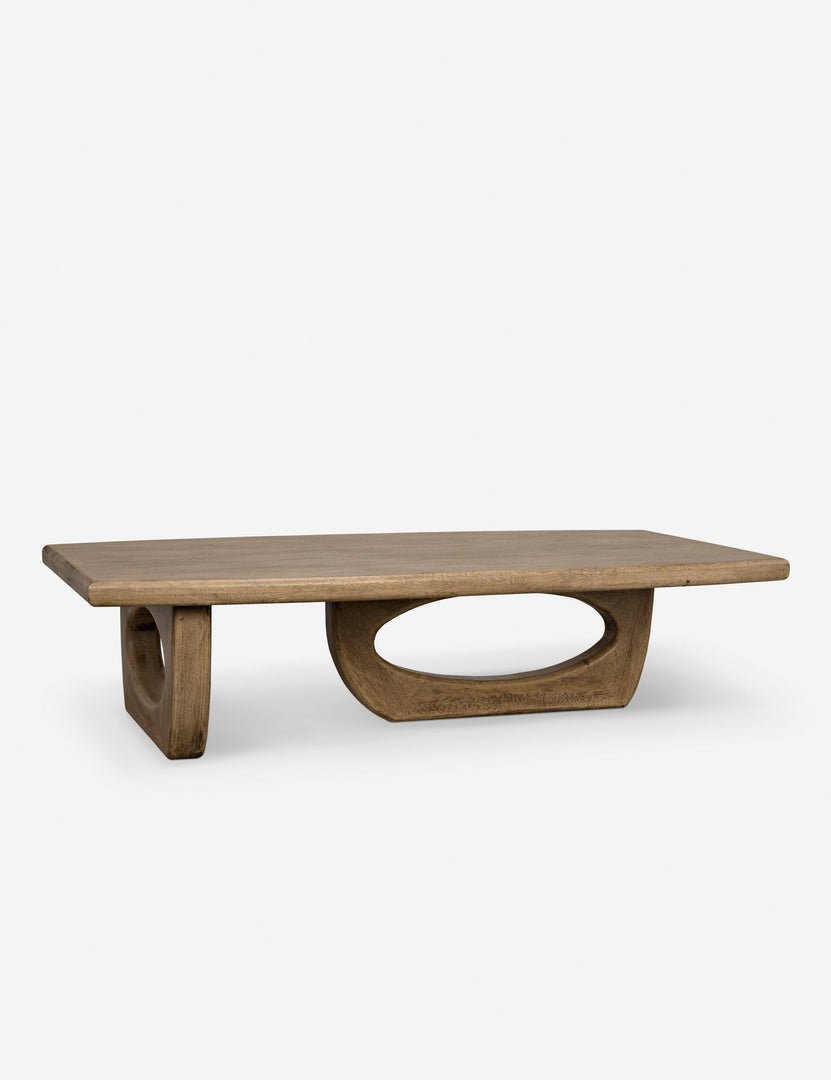 | Angled view of the Doris walnut coffee table with cutout oval legs