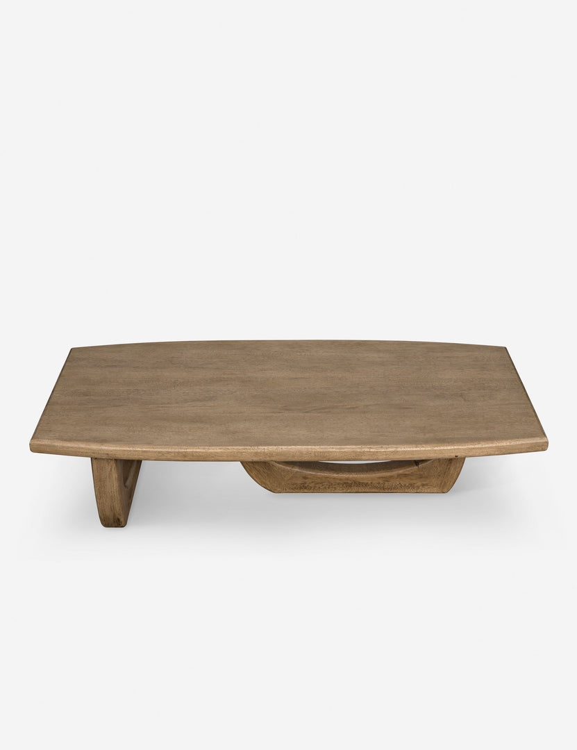 | Angled-upper view of the Doris walnut coffee table with cutout oval legs