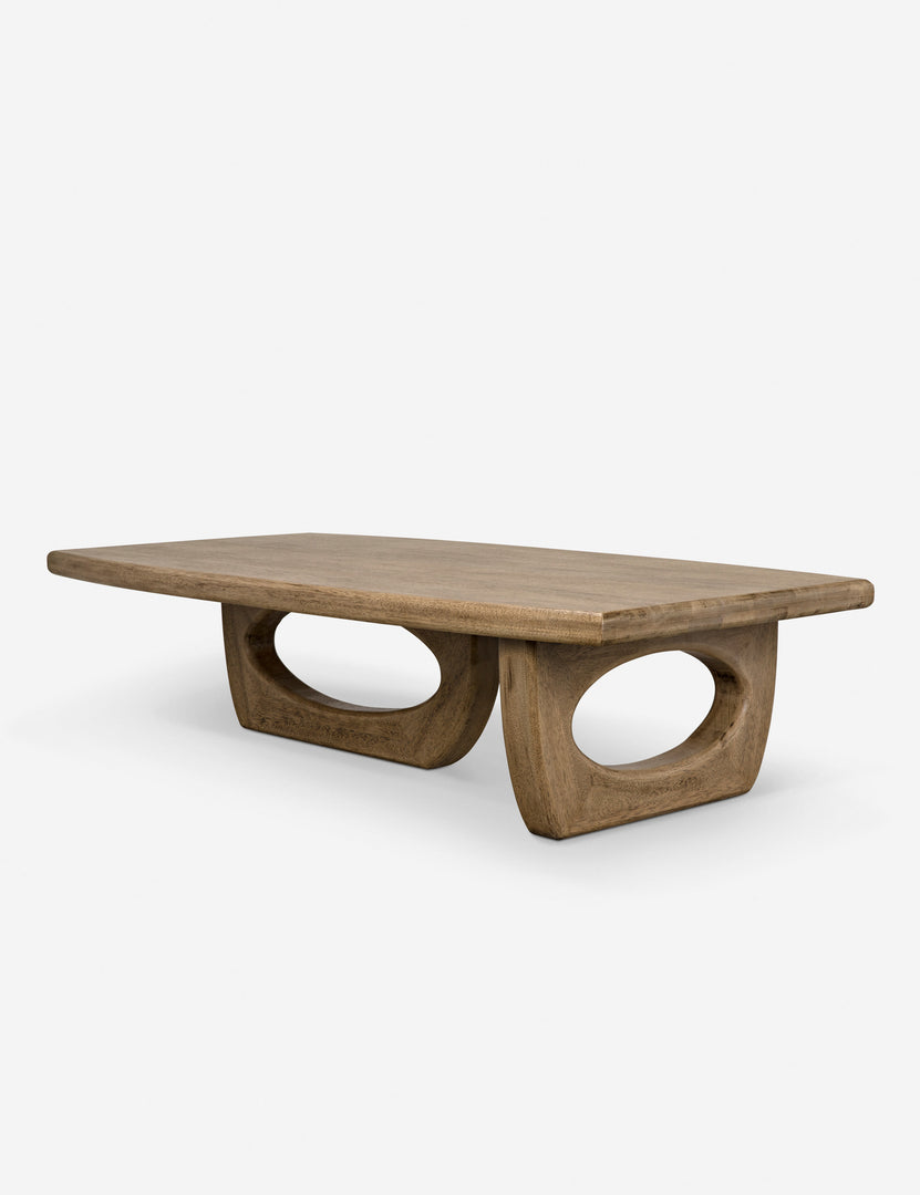 | Angled view of the Doris walnut coffee table with cutout oval legs