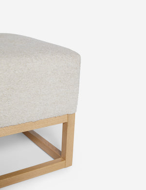 Close up of the airy wooden frame on the bottom of the Grasmere Taupe Boucle Ottoman