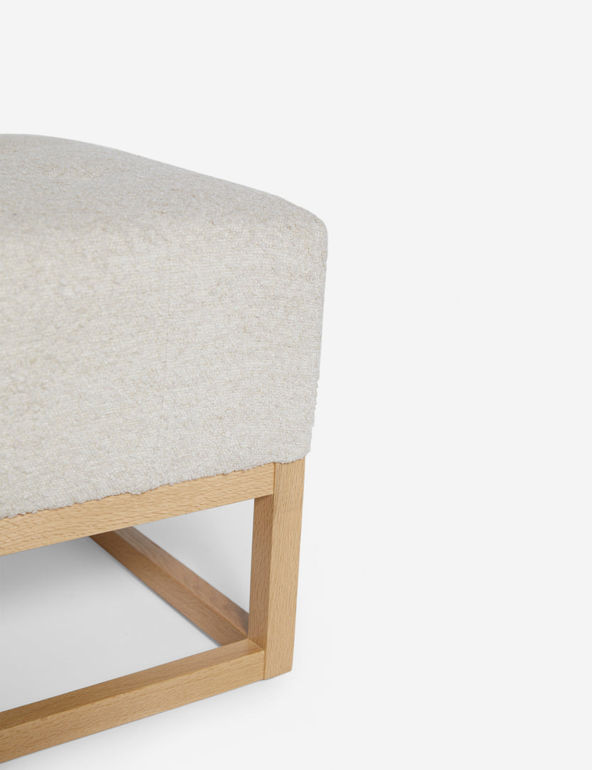 #color::taupe-boucle | Close up of the airy wooden frame on the bottom of the Grasmere Taupe Boucle Ottoman