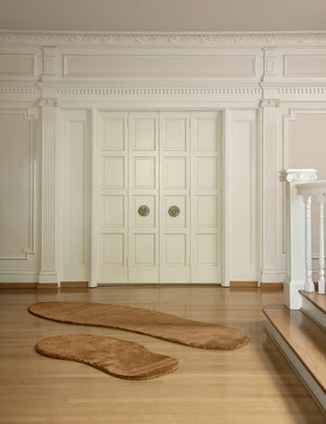 Both sizes of the Rangely Rug lay in an open room in front of two white accented french doors
