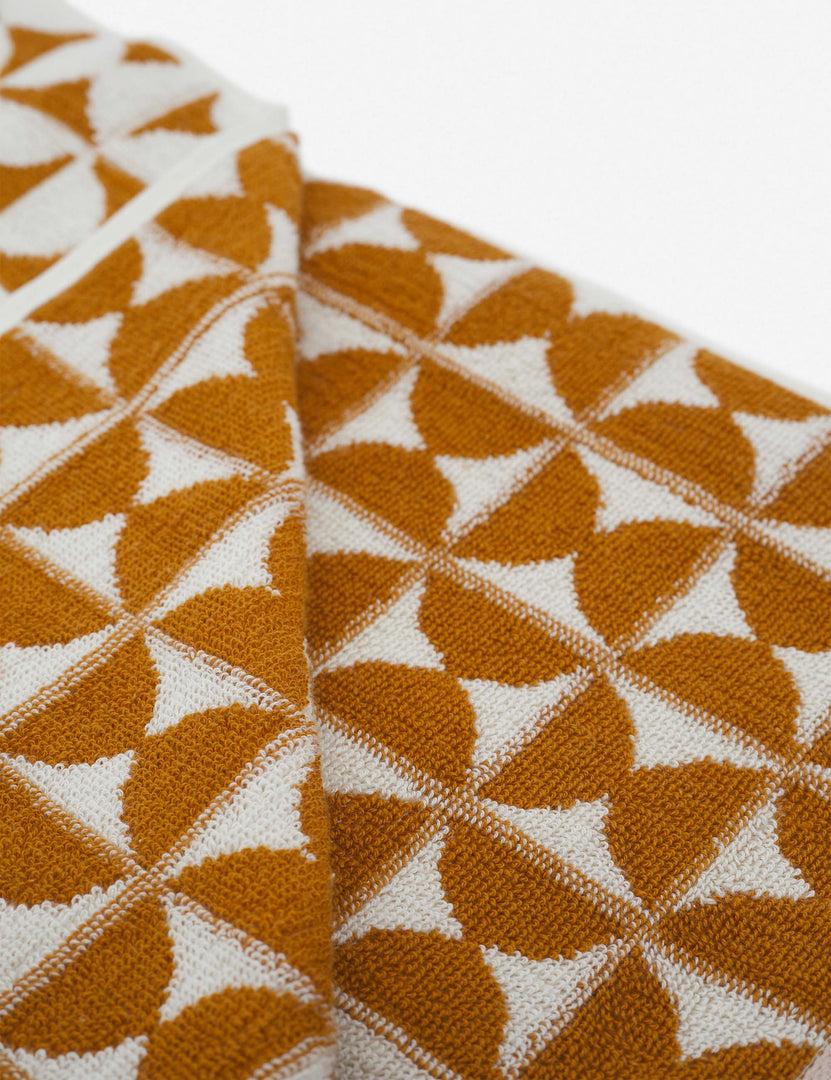 #color::sudan-brown-moon | Close-up of the Harper orange and white towel by house number 23 with orange half-moon designs