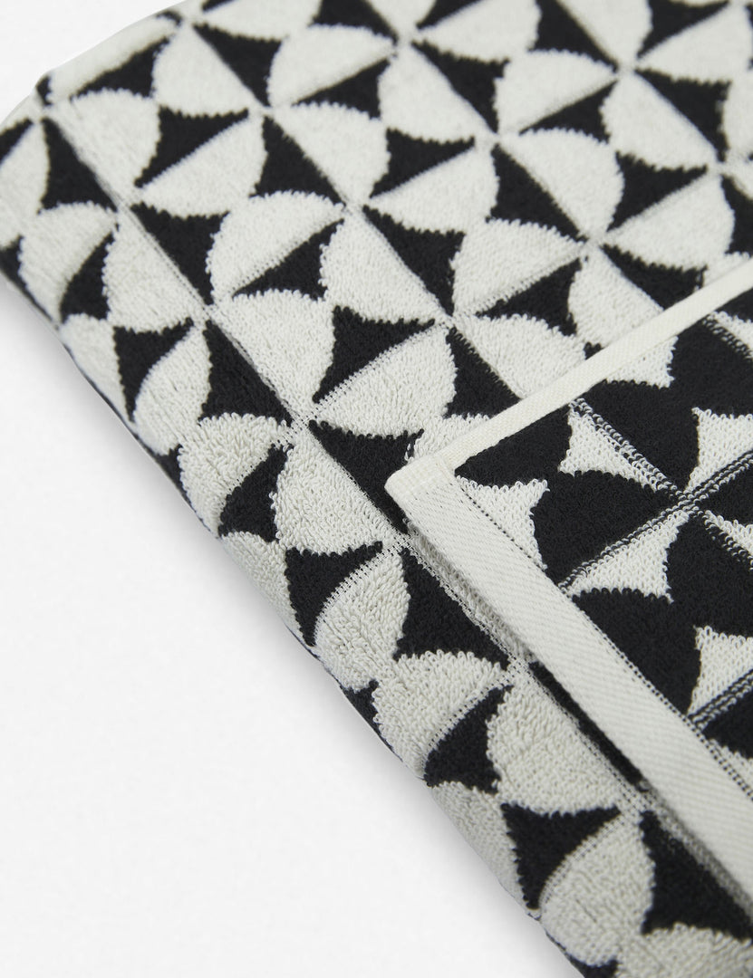 #color::meteorite | Close-up of the Harper black and white towel by house number 23 with white half-moon designs