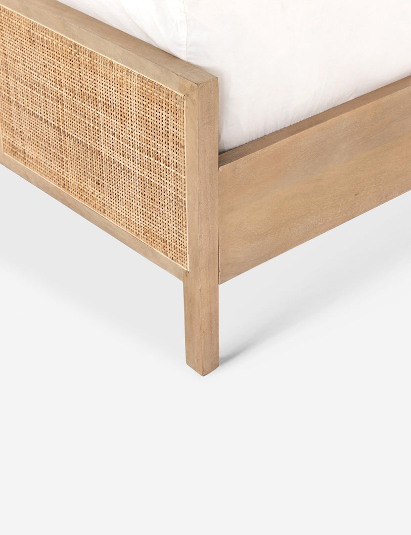 #color::natural #size::twin  | Close-up angled side view of the light wood base and cane detailing on the Hannah bed.