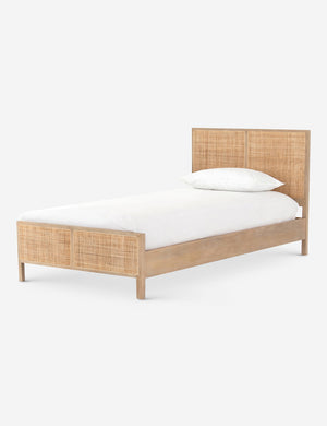 Side view of the Hannah bed with light wood cane bed frame.