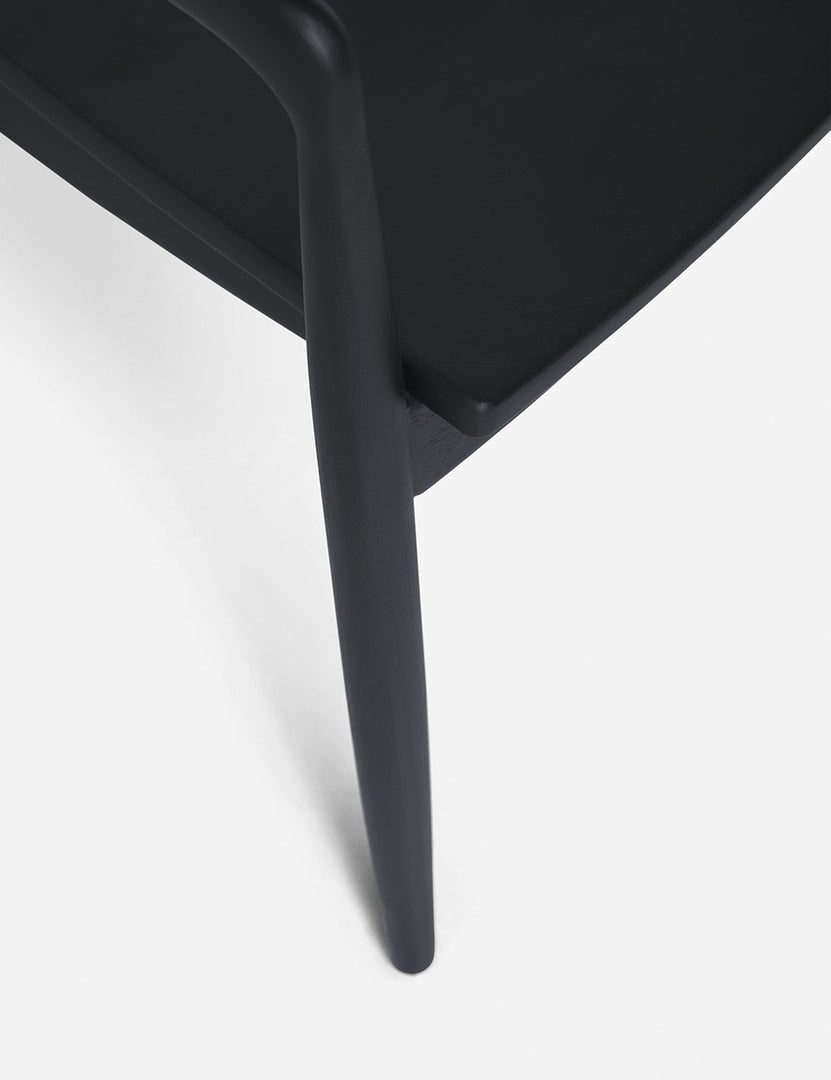 #color::Black | The leg and seat of the Ida Black Dining Arm Chair