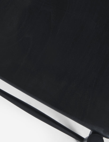 #color::Black | Detailed view of the black teak wood on the base of the Ida dining chair.