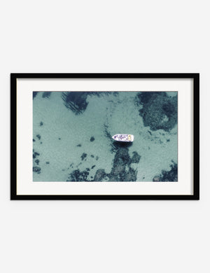 Aerial Ocean Bliss Photography Print in a black frame featuring an aerial view of a boat on shallow waters by Ingrid Beddoes