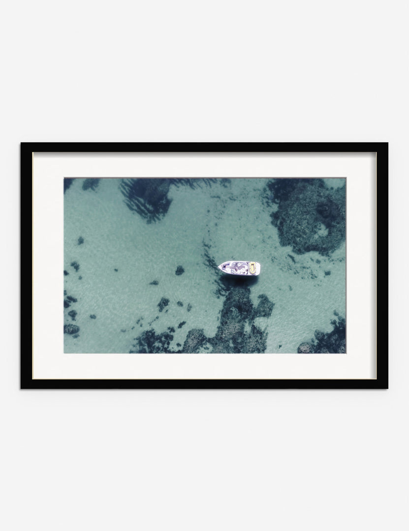 #frame-option::framed #color::black #size::255--x-175- #size::355--x-235- #size::455--x-295- | Aerial Ocean Bliss Photography Print in a black frame featuring an aerial view of a boat on shallow waters by Ingrid Beddoes