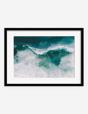 Crashing Waves Photography Print in a black frame that features an aerial scene of crashing waves by Ingrid Beddoes