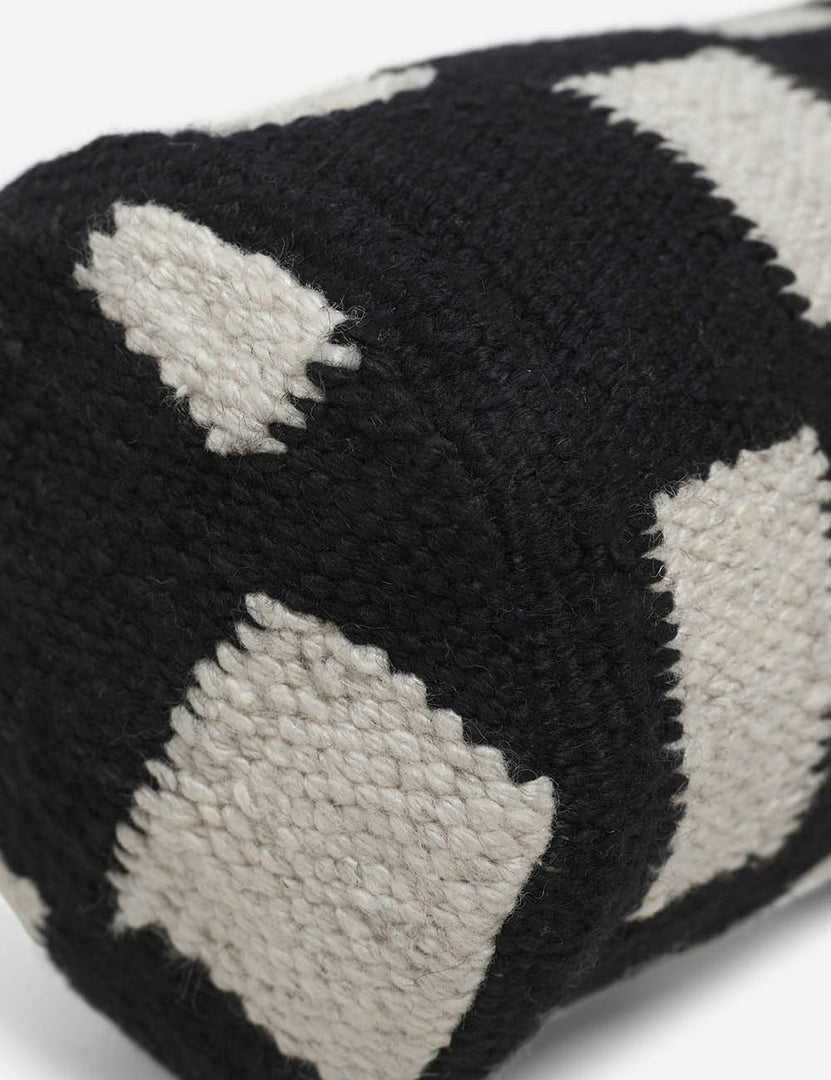 #color::black | Angled close up of the Irregular black and white Checkerboard Bolster Pillow by Sarah Sherman Samuel