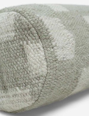 Angled close up of the Irregular khaki green and white Checkerboard Bolster Pillow by Sarah Sherman Samuel