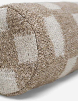 Angled close up of the Irregular taupe and white Checkerboard Bolster Pillow by Sarah Sherman Samuel