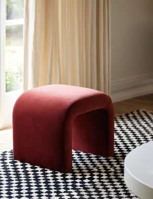 The Tate Paprika Stool sits on a black and white checkerboard rug