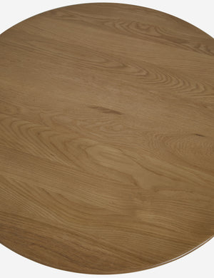 Overhead view of the Jota round natural oak coffee table with shelf.