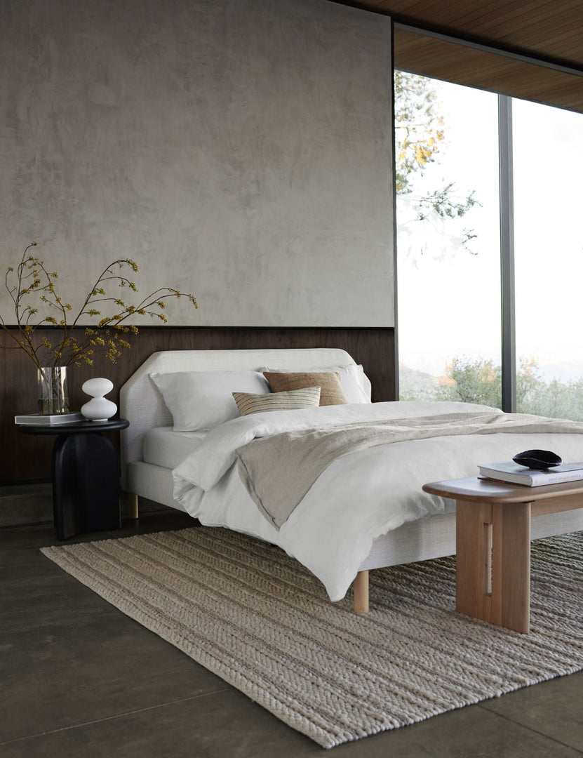 #color::white #size::queen #size::king #size::twin #size::cal-king | The European Flax Linen white Duvet Set by Cultiver lays on a white linen framed bed in a bedroom with floor to ceiling windows, the black nera nightstand, and a woven cream rug