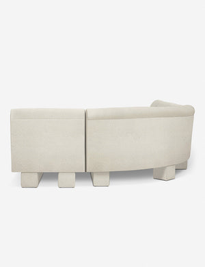 Rear view of the side of the Lena right-facing white boucle sectional sofa with upholstered beam legs.