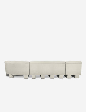 Rear view of the entire Lena right-facing white boucle sectional sofa with upholstered beam legs.