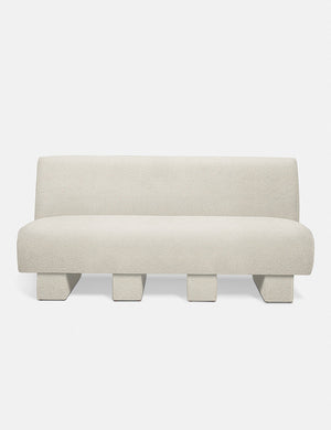 Centerpiece of the Lena white boucle sectional sofa with upholstered beam legs