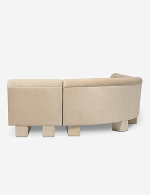 Rear view of the side of the Lena left-facing beige velvet sectional sofa with upholstered beam legs.