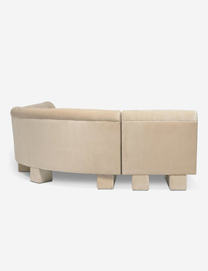 Rear view of the side of the Lena right-facing beige velvet sectional sofa with upholstered beam legs.