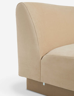 Side view of the  Centerpiece of the Lena beige velvet sectional sofa with upholstered beam legs