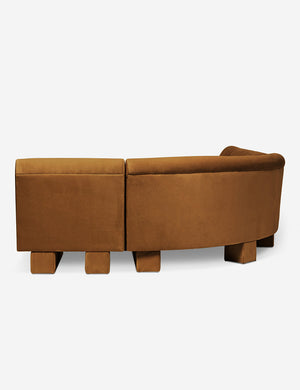 Rear view of the side of the Lena left-facing cognac velvet sectional sofa with upholstered beam legs.