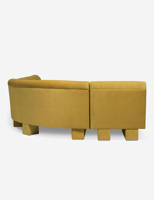 Rear view of the side of the Lena left-facing yellow velvet sectional sofa with upholstered beam legs.