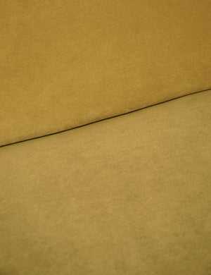 Where the back and seat of the Lena Goldenrod Velvet armless sofa meet