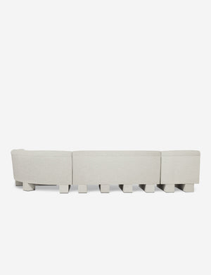 Rear view of the entire Lena right-facing natural linent sectional sofa with upholstered beam legs.