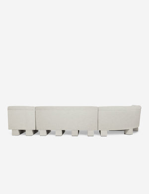 Rear view of the entire Lena left-facing natural linen sectional sofa with upholstered beam legs.