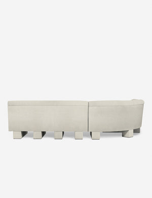 Rear view of the entire Lena right-facing white boucle sectional sofa with upholstered beam legs.