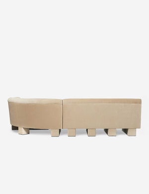 Rear view of the entire Lena left-facing beige velvet sectional sofa with upholstered beam legs.