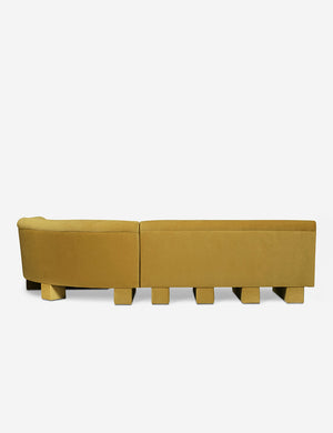 Rear view of the entire Lena right-facing yellow velvet sectional sofa with upholstered beam legs.