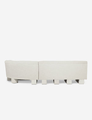 Rear view of the entire Lena right-facing natural linent sectional sofa with upholstered beam legs.