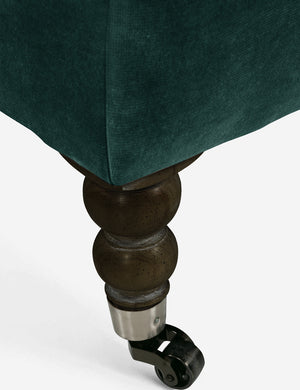 The ornate curved legs with wheels on the fabienne green velvet sectional