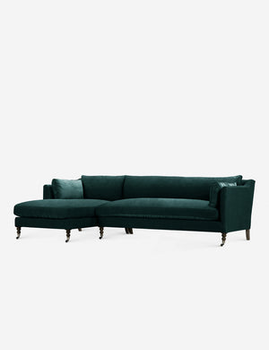 Fabienne left-facing green velvet sectional with antique curved legs in the back with ornate turned legs in the front with wheels