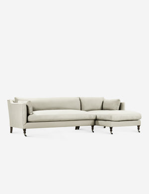 Fabienne left-facing natural sectional with antique curved legs in the back with ornate turned legs in the front with wheels